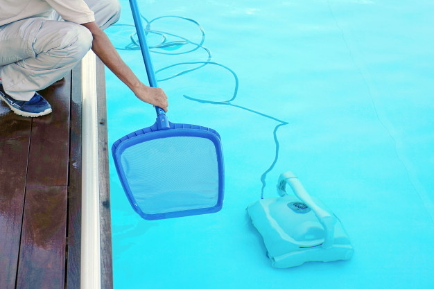 Cleaning Swimming Pool with Net and Vacuum